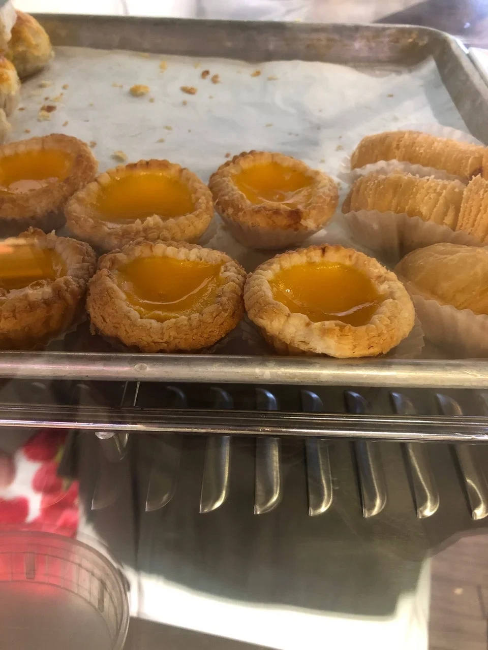 Egg tarts in a display case in the New Mulan branch photo gallery. Photograph date and specific service counter not established.